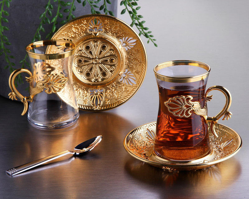 Gold tea set with a glass mug and teacup.